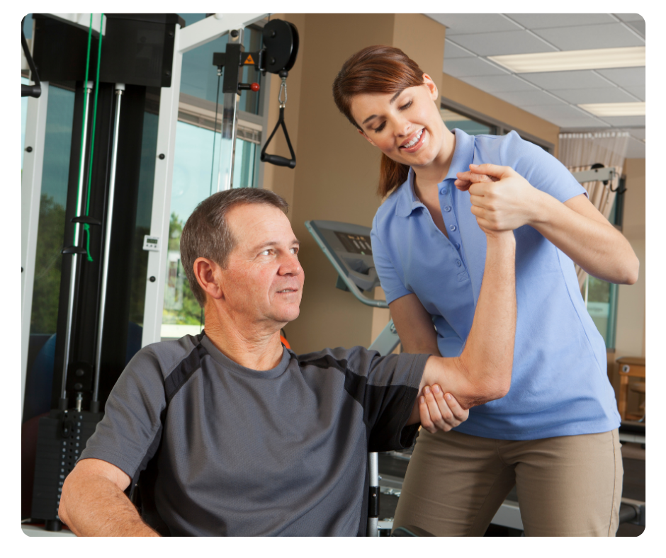 Qualified exercise physiologist providing hands-on guidance during rehab exercise session